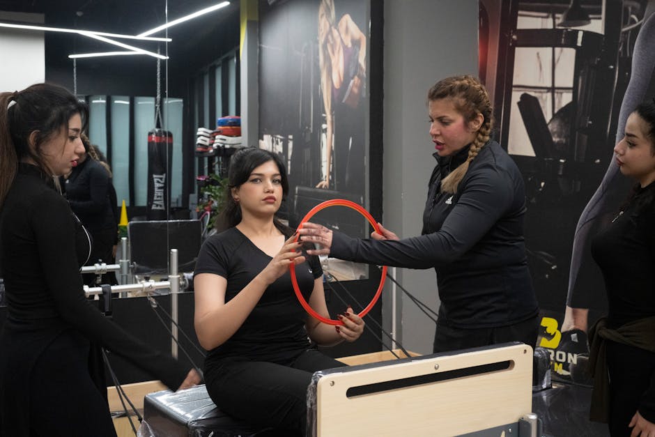 Women in a fitness class using Pilates equipment indoors. Enthusiastic and engaging session for health and fitness.